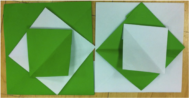 Grønne og hvite firkanter brettet i papir